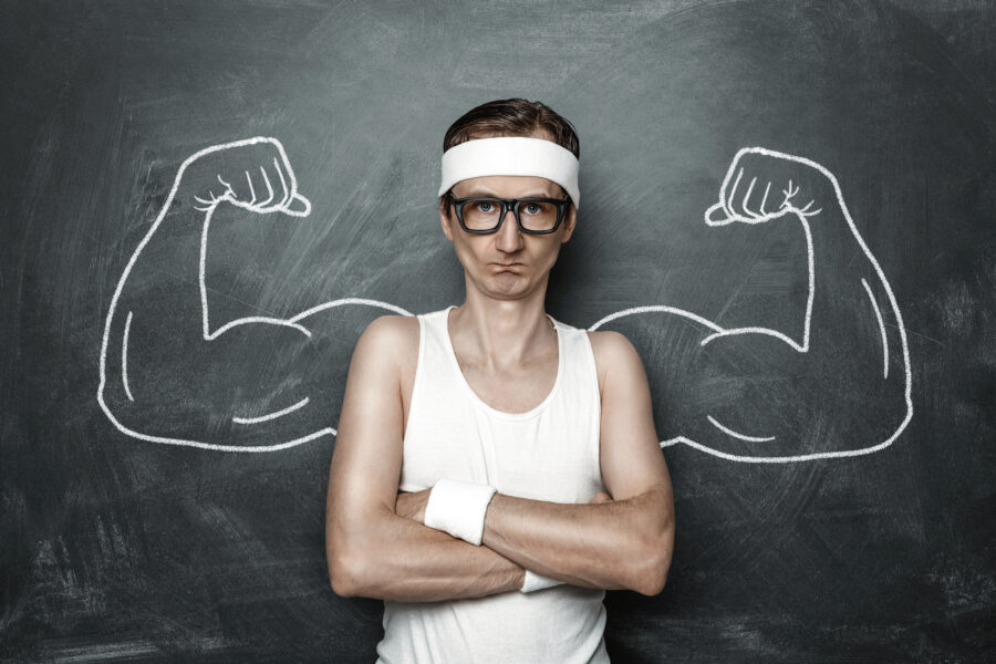 Person with small arms in front of picture of muscles